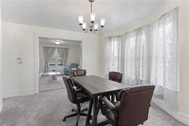 a view of a dining room with furniture and chandelier