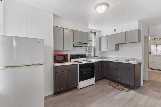 a kitchen with stainless steel appliances granite countertop a stove a sink and a refrigerator