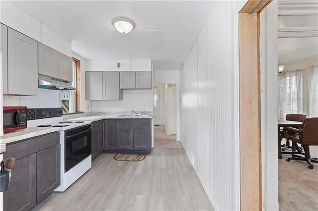 a kitchen with a sink and a stove top oven