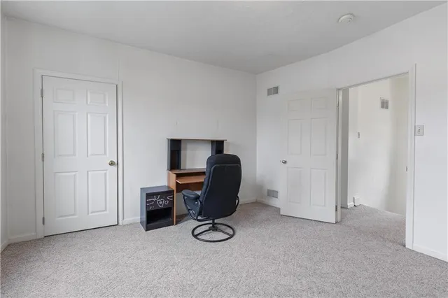 a view of workspace with furniture and closet