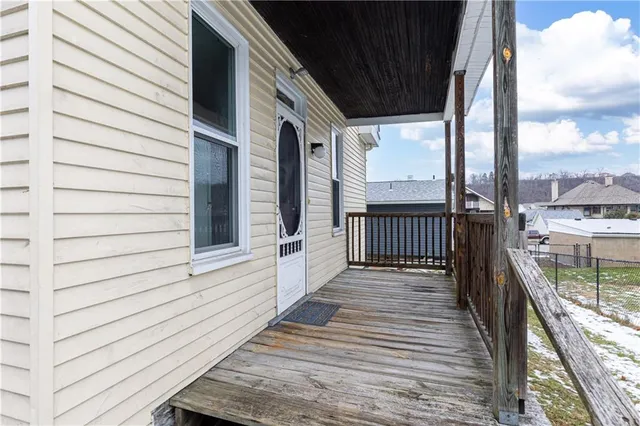 a view of a balcony with wooden floor