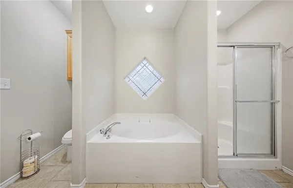 a white bath tub sitting next to a shower