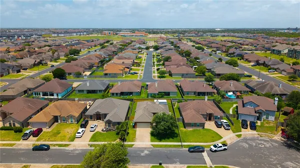 an aerial view of residential houses with outdoor space