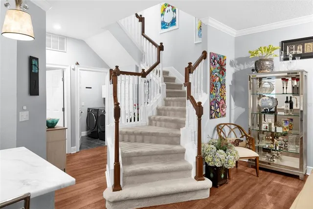 a living room with furniture a flat screen tv and a large window