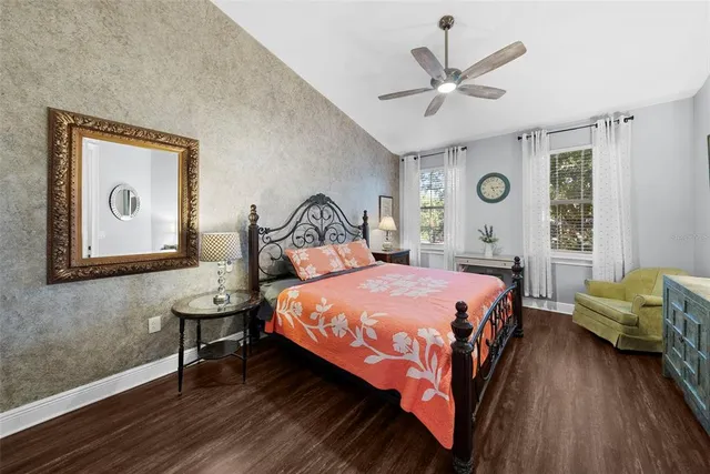 a bedroom with bed and paintings on the wall