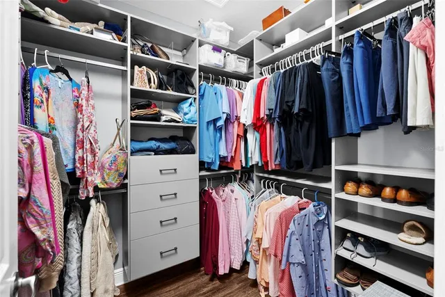 a bedroom with a bed a window and a flat screen television