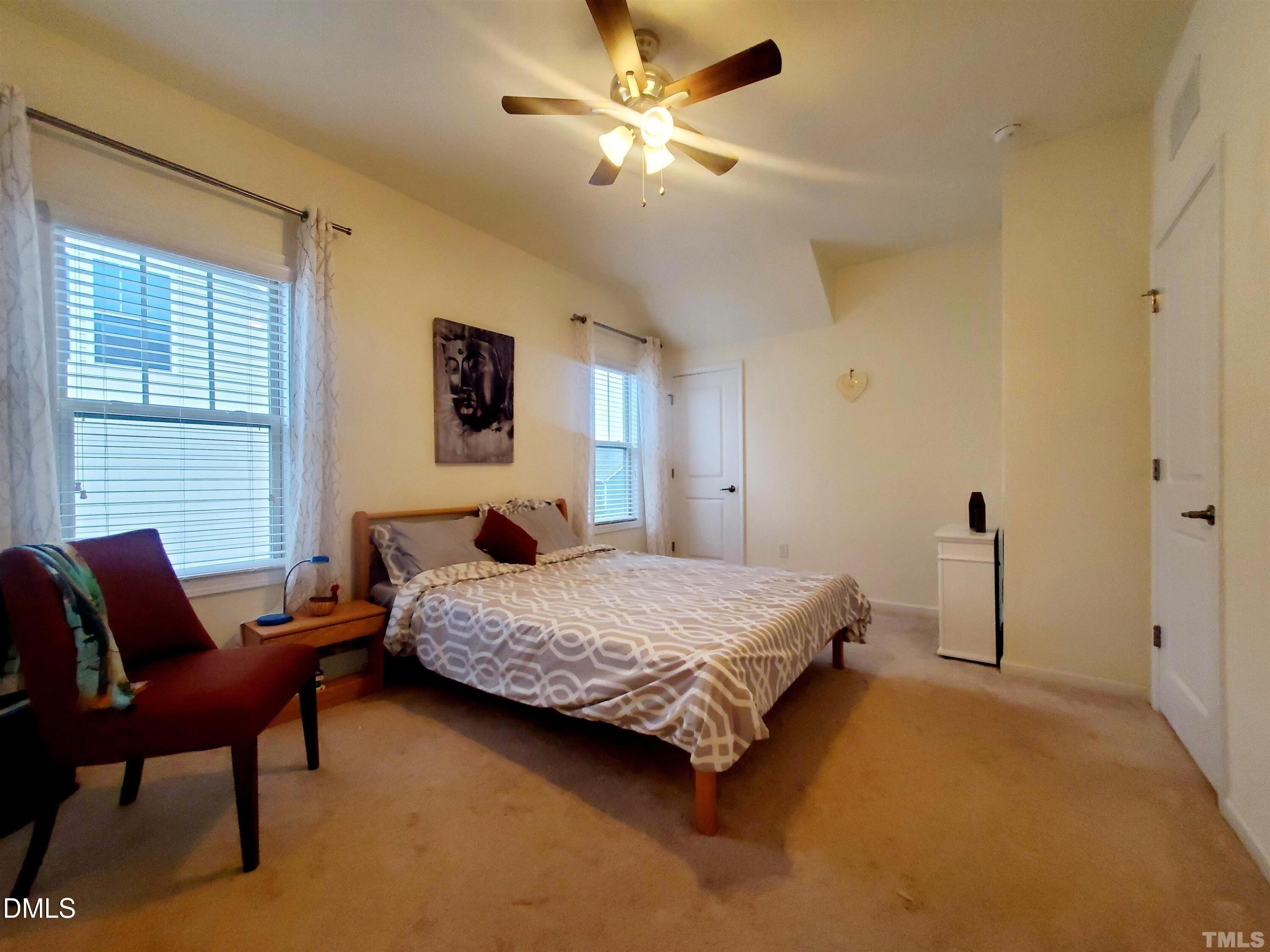 2700 Jockeys Rdg Trace Apex, NC 27502 - Photo 14 of 18 a bedroom with a bed and a chair