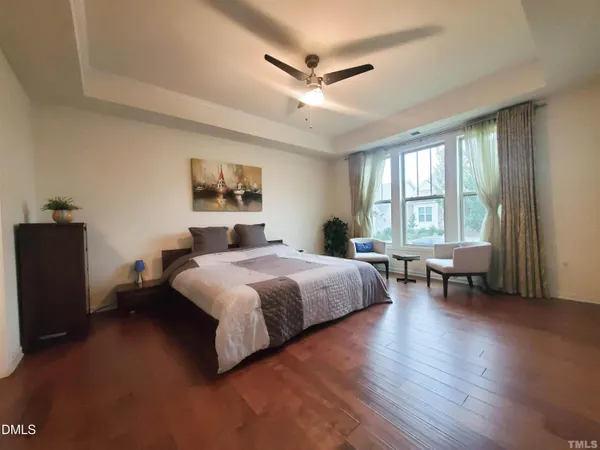 a bedroom with a large bed and a window