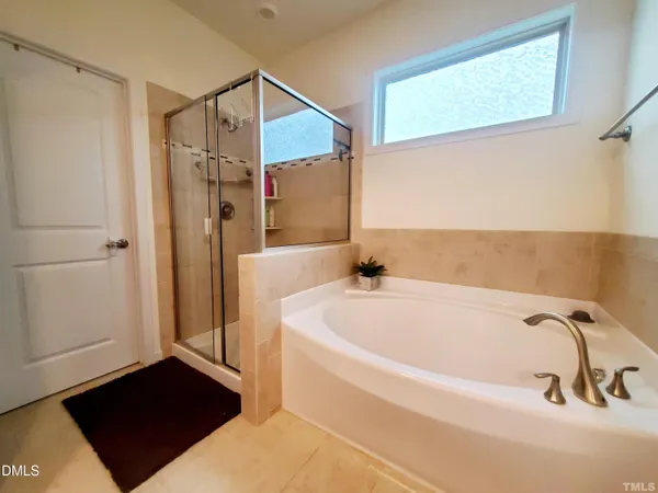 a bathroom with a tub and a shower