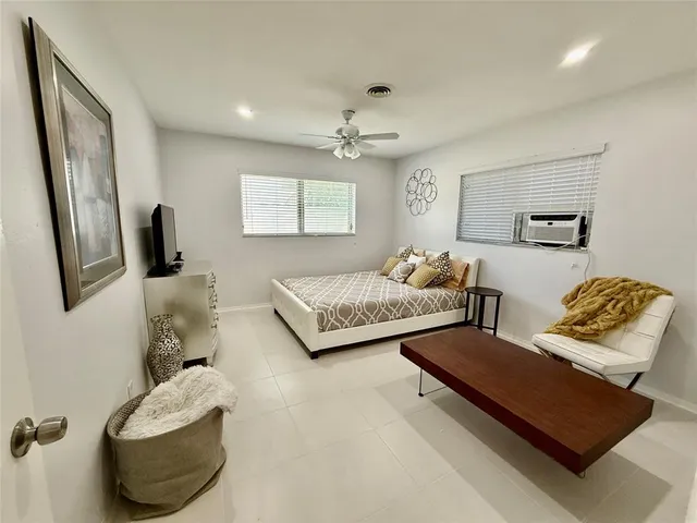a bedroom with furniture and a wooden floor