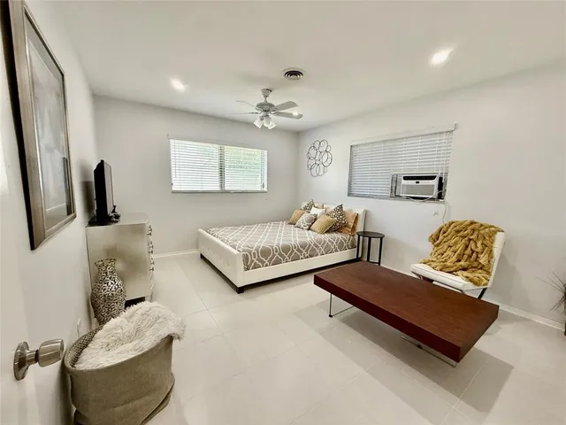 a bedroom with a bed and a couch