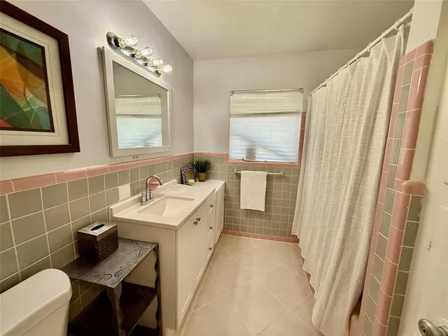 a bathroom with a sink a toilet and mirror