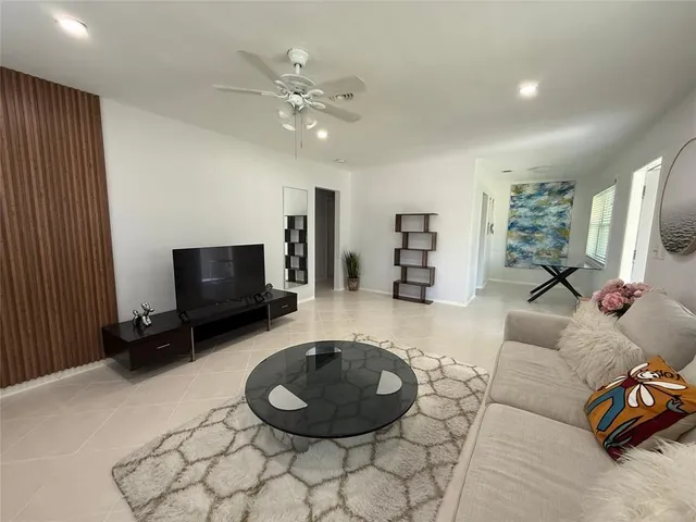 a living room with furniture and a flat screen tv