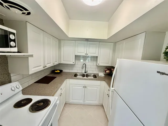 a kitchen that has a sink and a stove in it