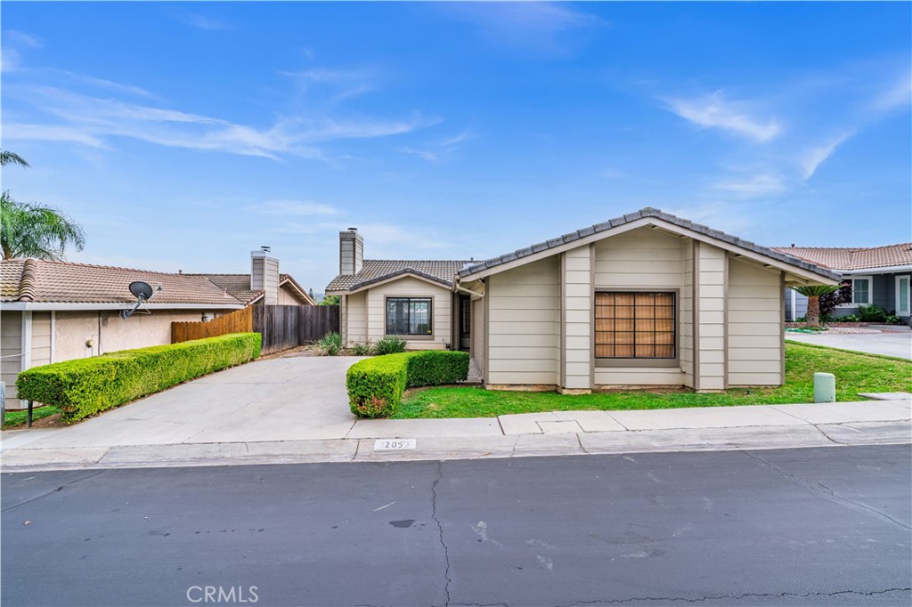 12052 Elk Boulevard Riverside, CA 92505 - Photo 2 of 25 a front view of a house with a yard and garage