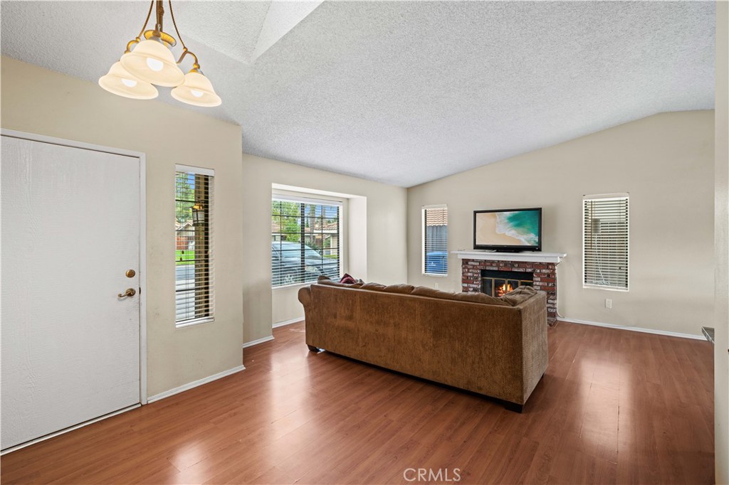 12052 Elk Boulevard Riverside, CA 92505 - Photo 3 of 25 a living room with furniture and a flat screen tv