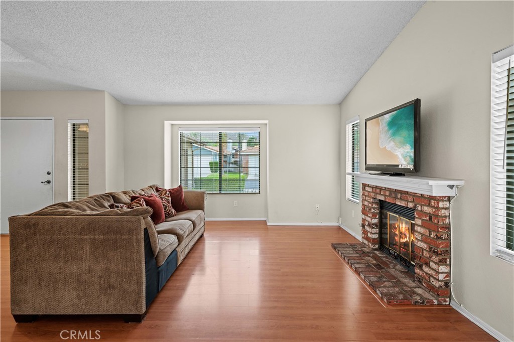 12052 Elk Boulevard Riverside, CA 92505 - Photo 4 of 25 a living room with furniture and a flat screen tv