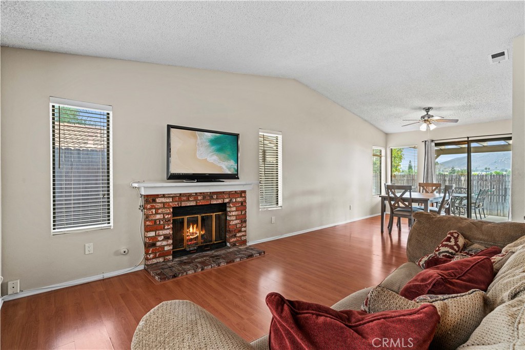 12052 Elk Boulevard Riverside, CA 92505 - Photo 5 of 25 a living room with furniture and a fireplace
