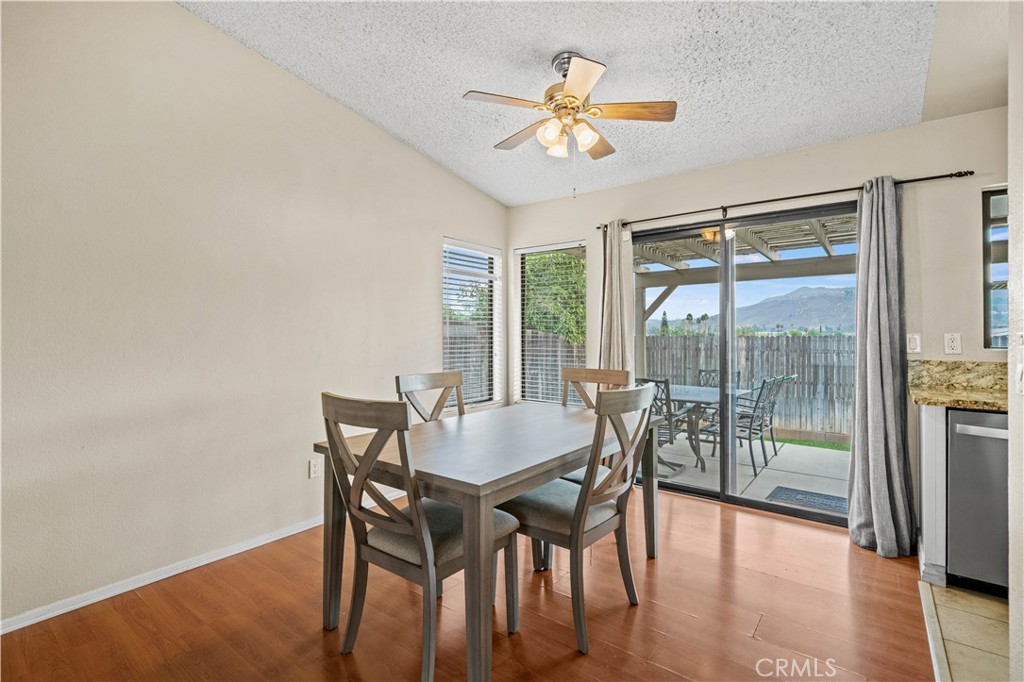 12052 Elk Boulevard Riverside, CA 92505 - Photo 6 of 25 a view of a dining room with furniture window and wooden floor