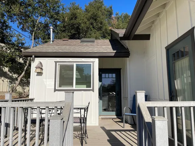 a view of house with backyard and furniture