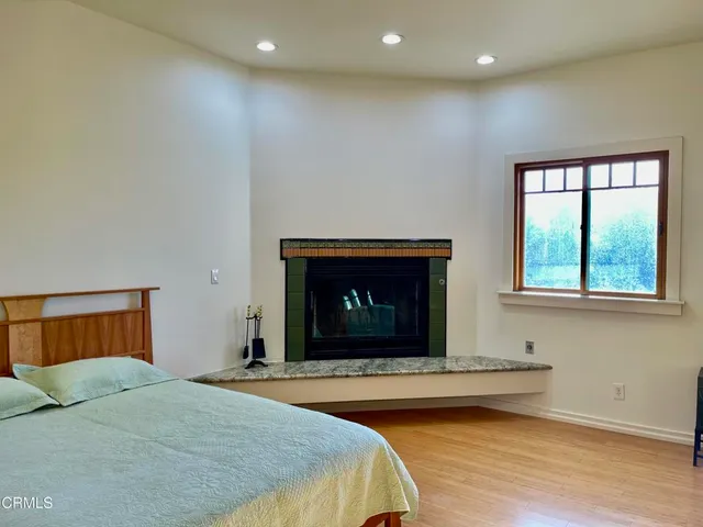 a bedroom with a bed and a fireplace
