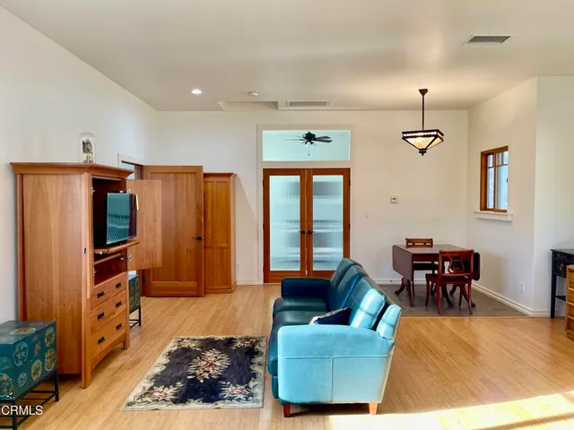 a living room with furniture a rug and a chandelier