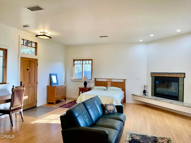 a bedroom with furniture and a fireplace