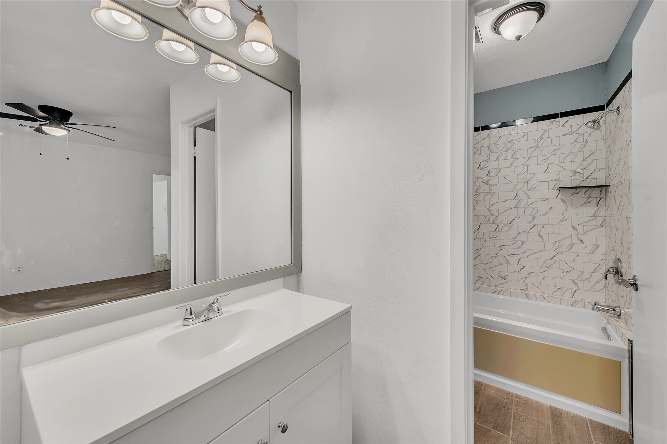 7209 Gunnison Pass Austin, TX 78724 - Photo 12 of 19 A well-appointed bath features a sleek vanity and a tub-shower combination with decorative tile surround.