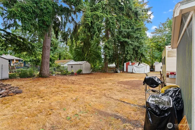 a view of a house with backyard and sitting area
