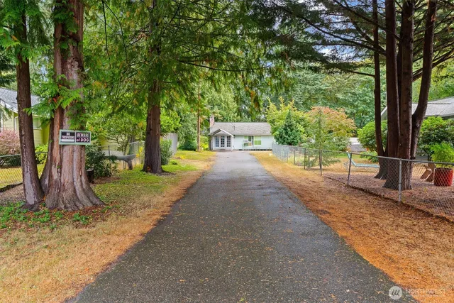 a bedroom with furniture and a large window