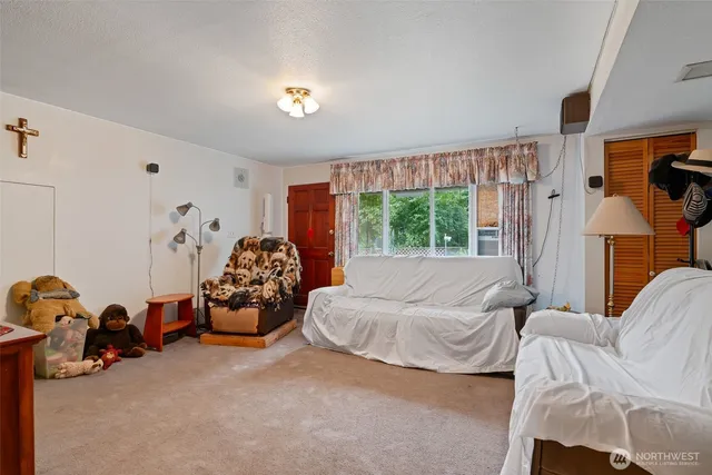 a dining hall with stainless steel appliances kitchen island granite countertop furniture and a chandelier