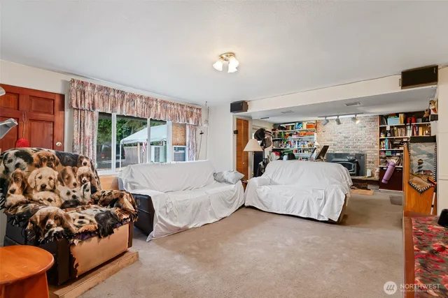 a kitchen with a sink appliances cabinets and a large window