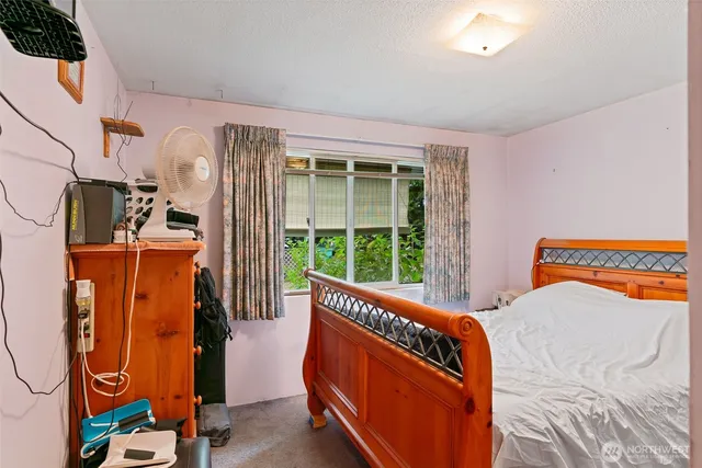 a bed room with two bed and a flat screen tv