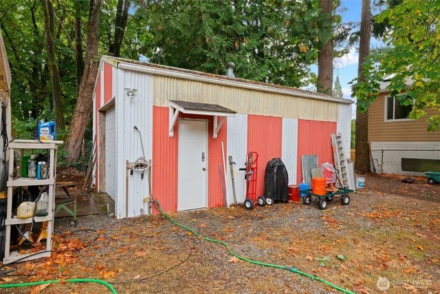 a backyard of a house with table and chairs