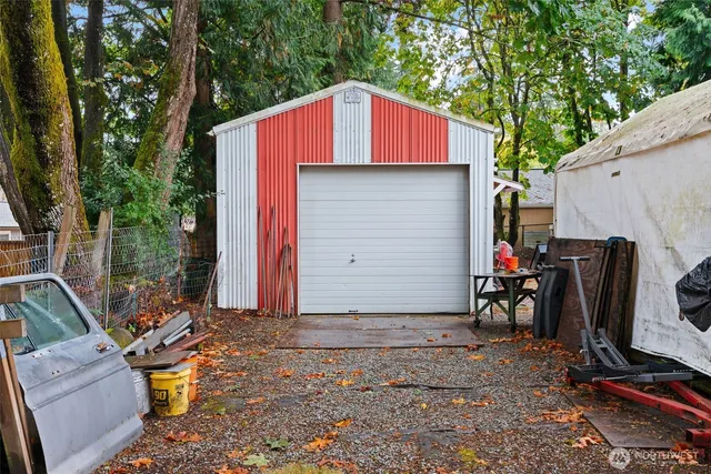 a view of backyard with outdoor seating and plants