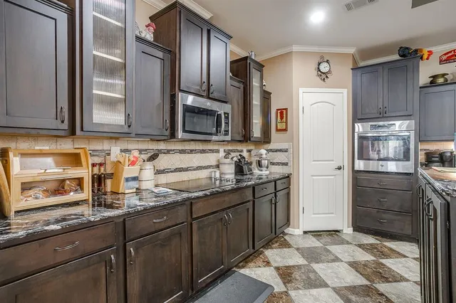 a kitchen with stainless steel appliances granite countertop a refrigerator and a sink