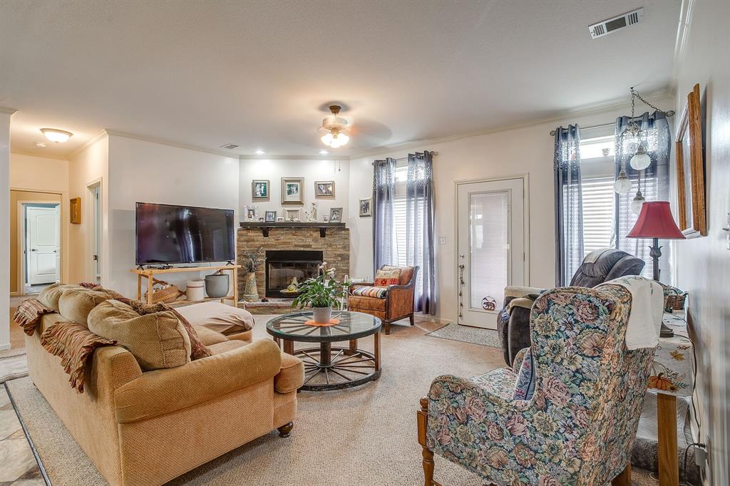13740 County Road 4041 Scurry, TX 75158 - Photo 15 of 40 a living room with furniture fireplace and flat screen tv