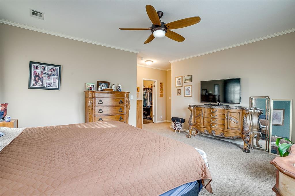 13740 County Road 4041 Scurry, TX 75158 - Photo 18 of 40 a bedroom with a bed and a flat screen tv