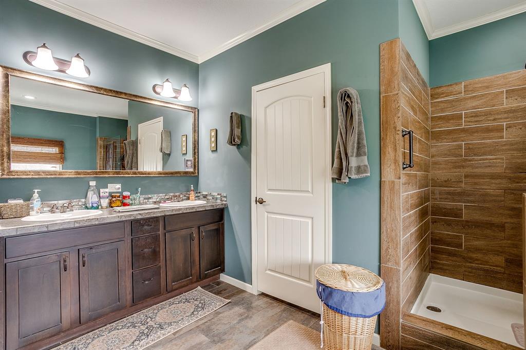13740 County Road 4041 Scurry, TX 75158 - Photo 20 of 40 a bathroom with a granite countertop sink toilet and shower