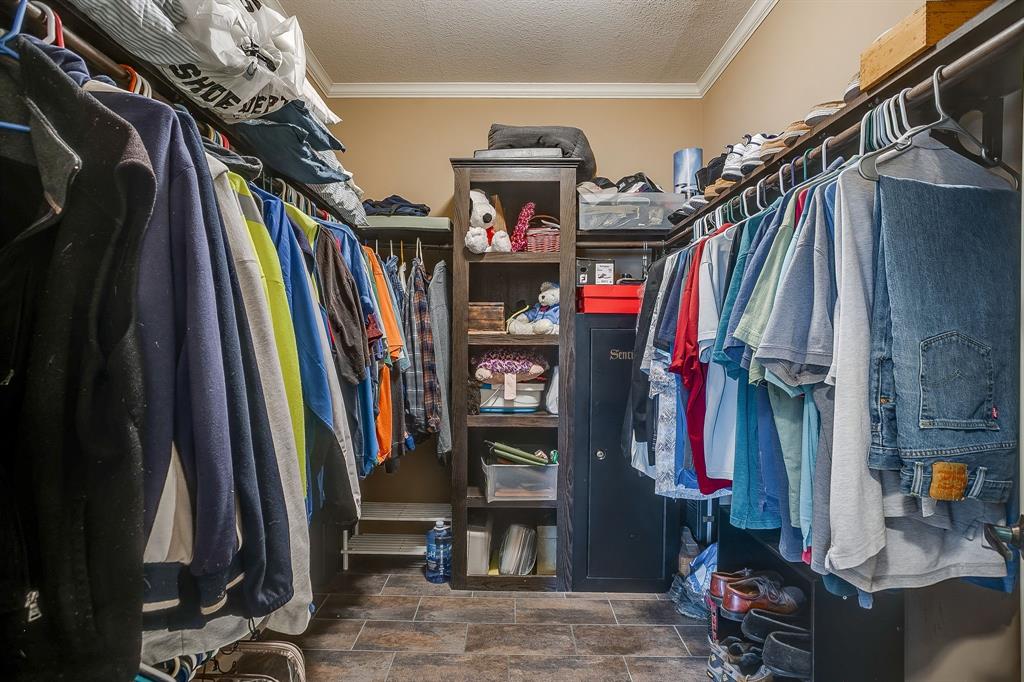 13740 County Road 4041 Scurry, TX 75158 - Photo 21 of 40 a view of walk in closet with clothes