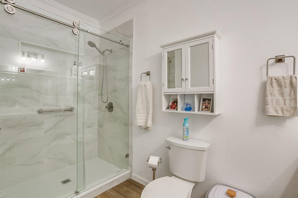 13740 County Road 4041 Scurry, TX 75158 - Photo 25 of 40 a bathroom with a shower a toilet and a sink