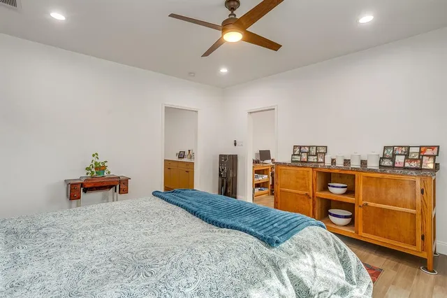 a bedroom with a bed and wooden floor