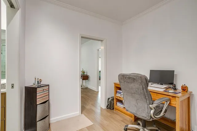 a view of a workspace with furniture and wooden floor