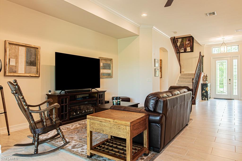 7761 Bucks Run Drive Naples, FL 34120 - Photo 11 of 50 a living room with furniture and a flat screen tv