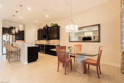 a kitchen with stainless steel appliances kitchen island granite countertop a sink and cabinets