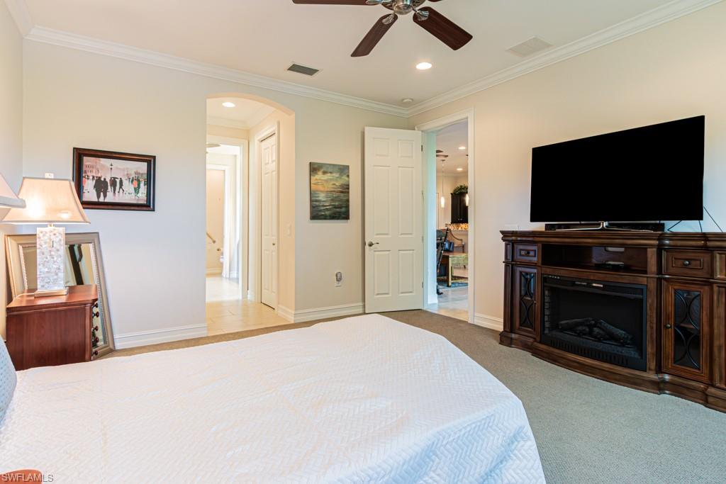 7761 Bucks Run Drive Naples, FL 34120 - Photo 19 of 50 a bedroom with a bed and a flat screen tv