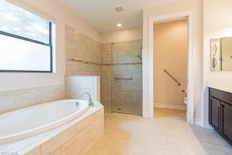 a bathroom with a bathtub and a shower