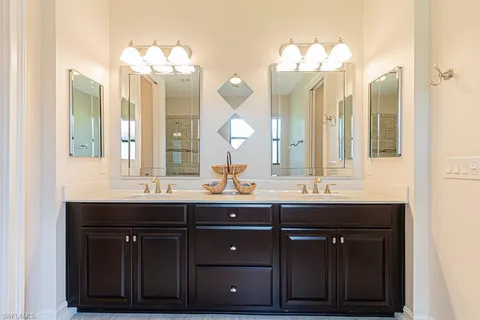 a bathroom with a double vanity sink and a mirror