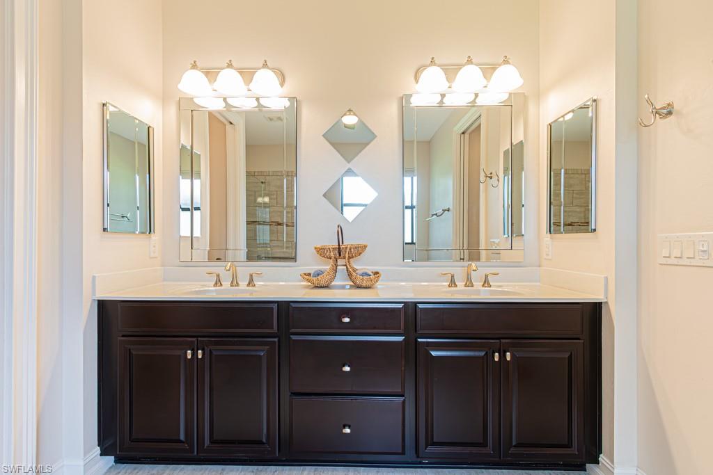 7761 Bucks Run Drive Naples, FL 34120 - Photo 22 of 50 a bathroom with a double vanity sink and a mirror