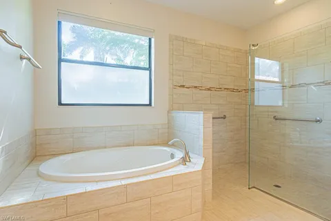 a white bath tub sitting next to a window